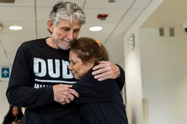 Two people hug at a hospital