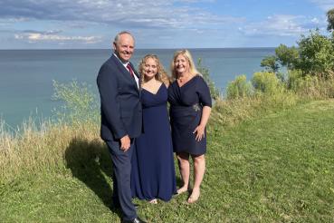 Steve Stark (left) smiles with his daughter and wife.
